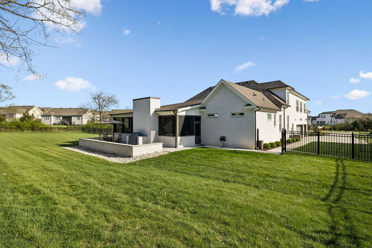 The backyard offers abundant green space to enjoy.