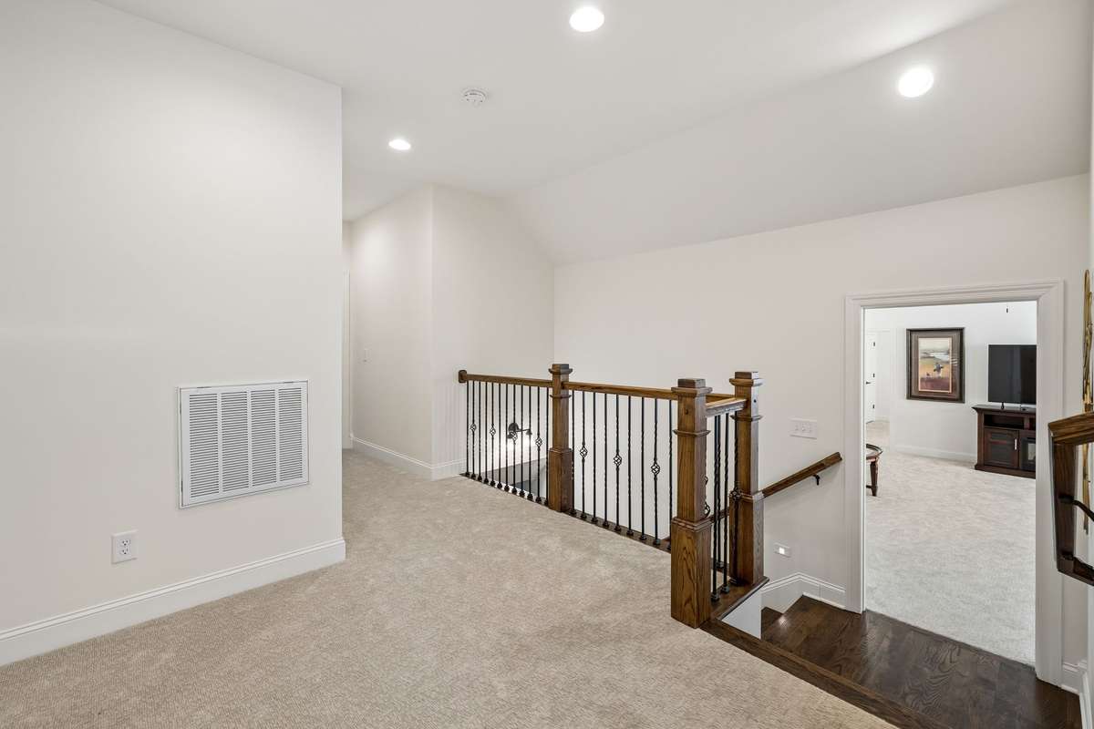 The stairwell leads to both the bonus room and the upstairs bedrooms.