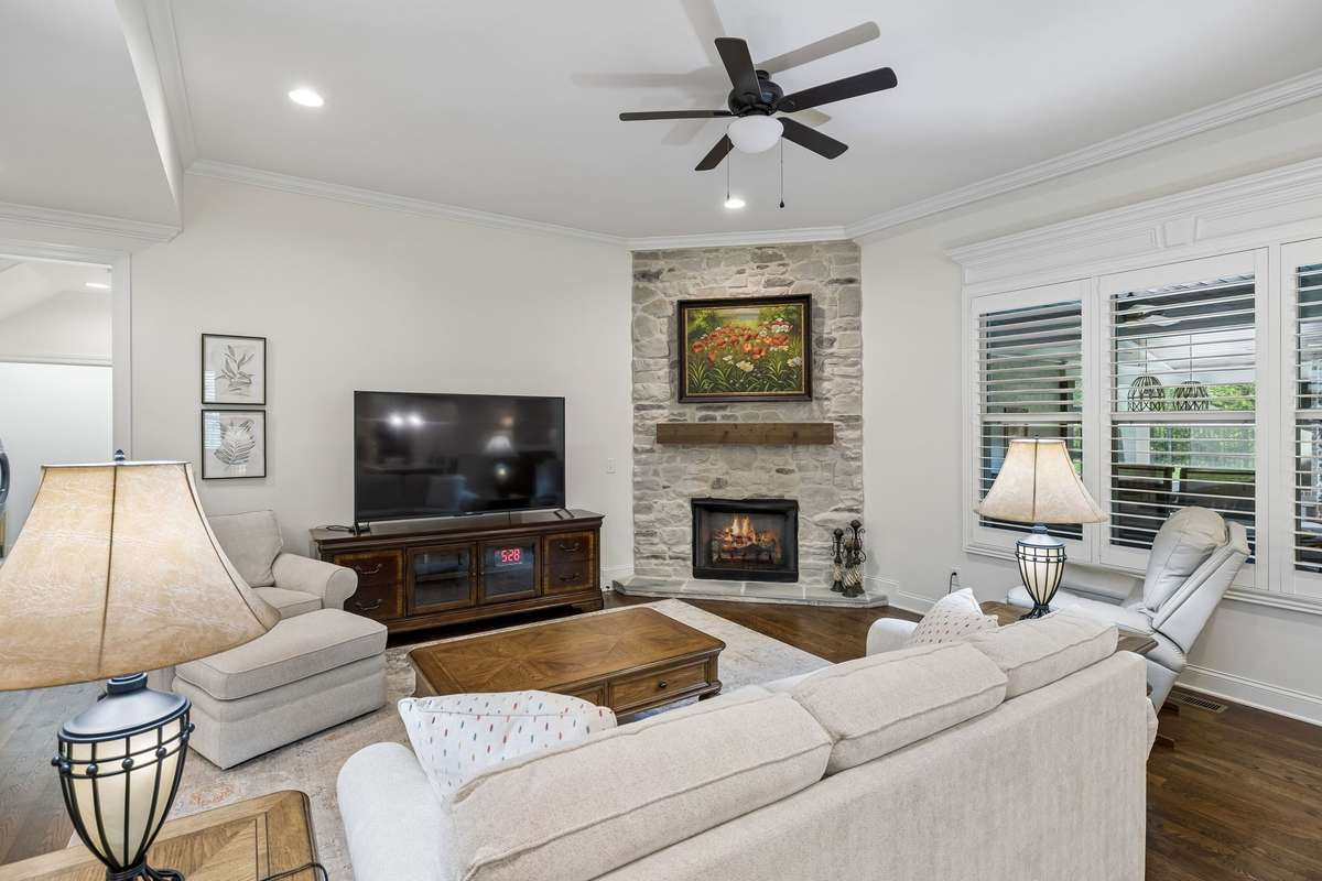 The stone fireplace includes gas logs for convenient use.