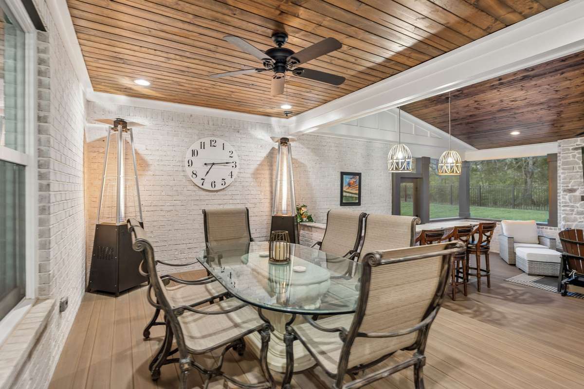 Right off the kitchen and dining room is this spacious area to enjoy a meal on the porch.