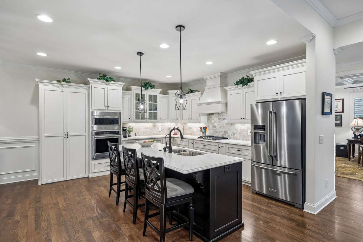 The kitchen cabinets provide ample storage, plus a hidden walk-in pantry.