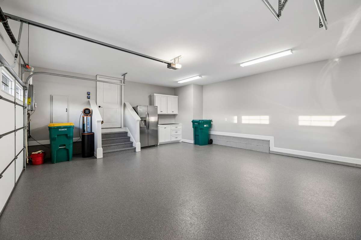 The three-car garage is in pristine condition and includes built-in cabinets for storage.