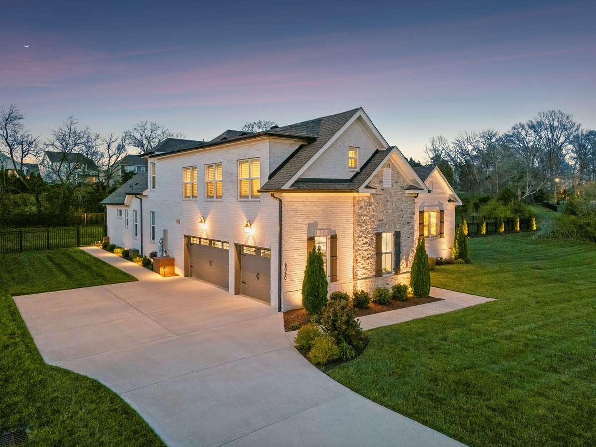Enjoy the convenience of a three-car garage and large concrete driveway.