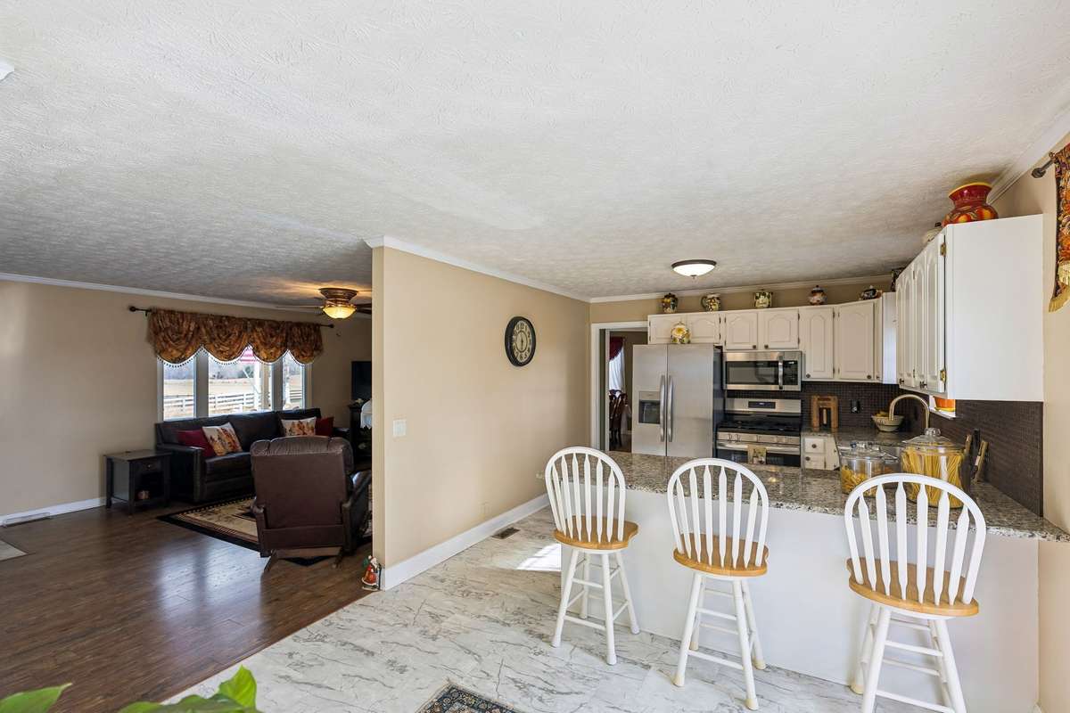 Kitchen with the bar!  Painted cabinets with new tops and stainless appliances.