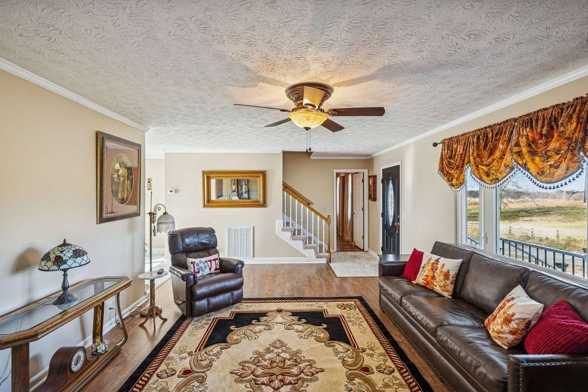 Large living area with laminate flooring.