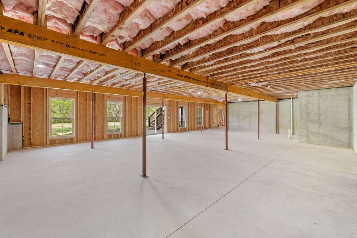 This is the roughed in area in the Basement.  There is plumbing roughed in for Kitchen and Full Bath.  There is a Separate Breaker Box for this area.  Large walk out doors for convenience