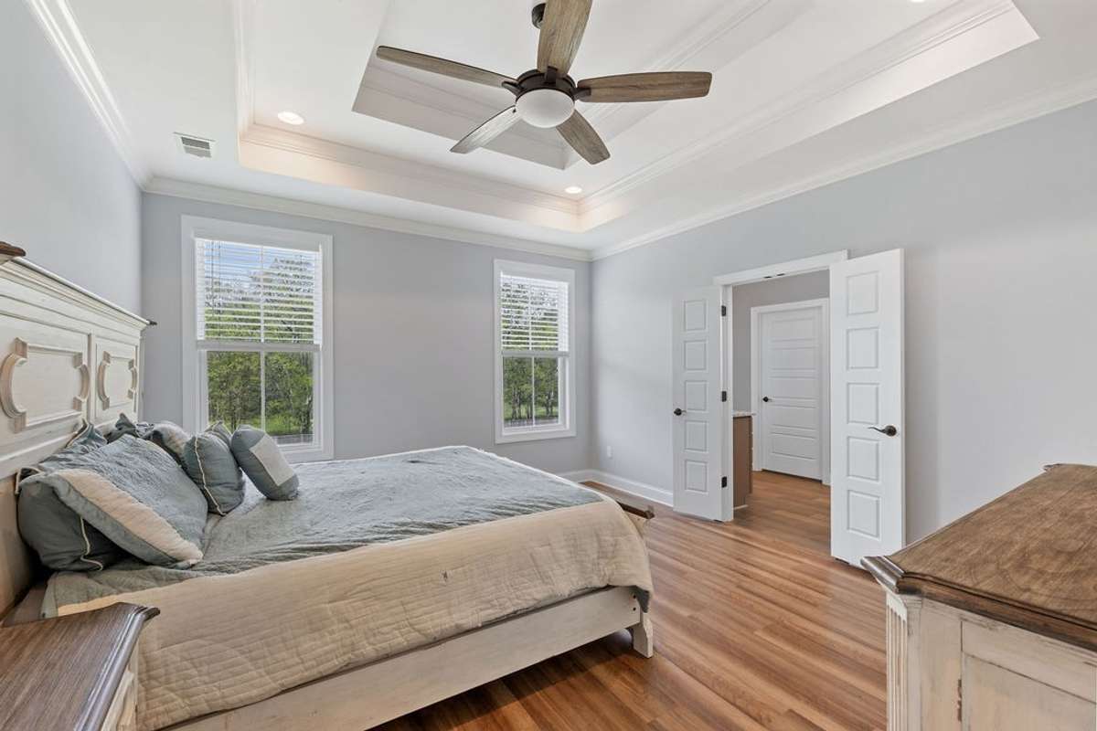 Master Bedroom with Trey Ceiling, Hardwood Floors and a view from every window