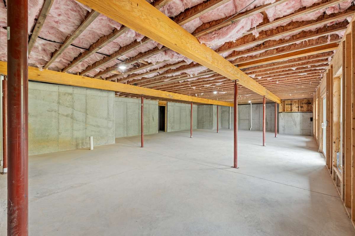 The other end of the 2500 sq. ft of roughed in area in the basement with a storm shelter on the left side of this picture.   It is the area under the front porch, very dry and poured concrete all around.