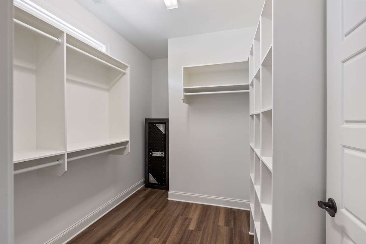 Huge Master Closet  with lots of hanging room for clothes and shoe racks