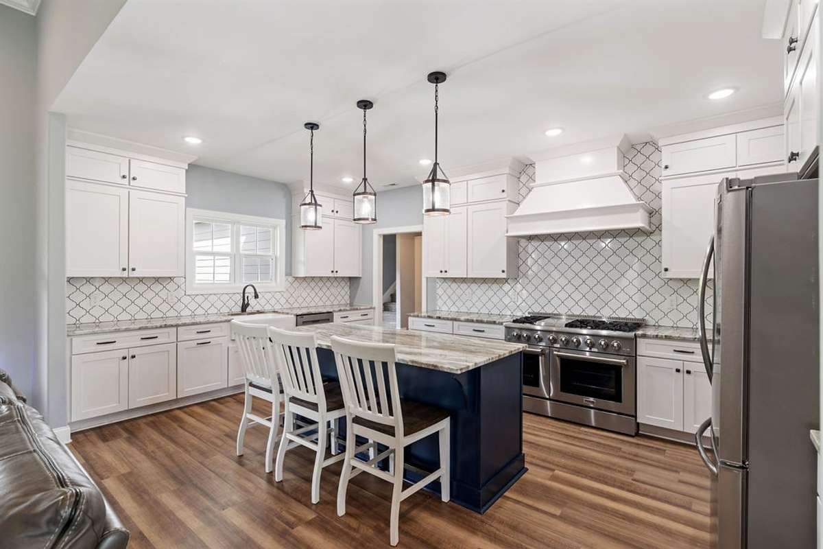 View of Large Island and the cabinets in the Kitchen.  There is a pantry in here and a large gas cooking stove