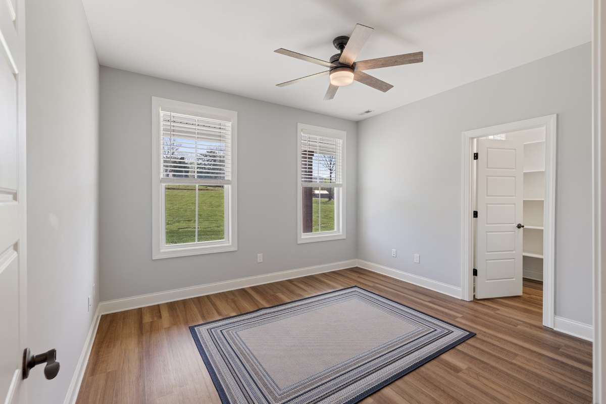 Bedroom #3 with Lots of Windows, Wood Floors, Large walk-in Closet and Ceiling Fan