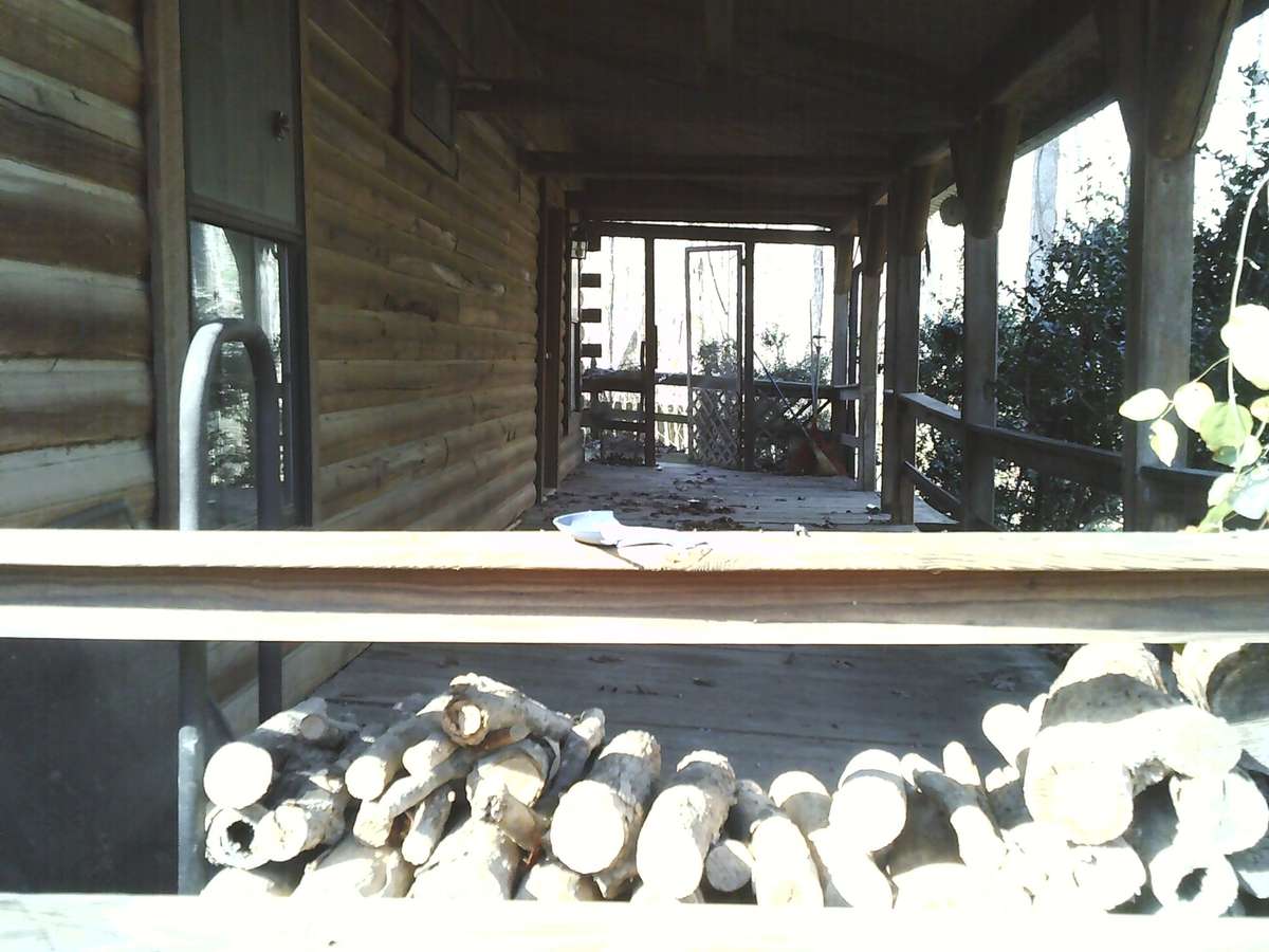 Front Porch from the side, showing opening to pool side. The porch used to be screened in.