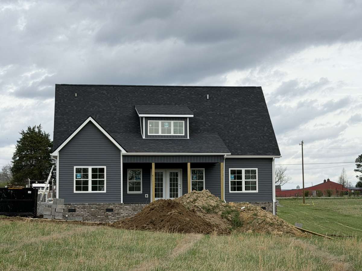 Back view of home w/covered porch