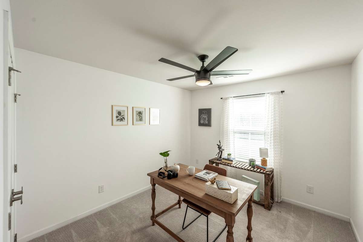 Well-sized guest bedroom with plenty of natural light, perfect for visitors or flexible use as a home office.
