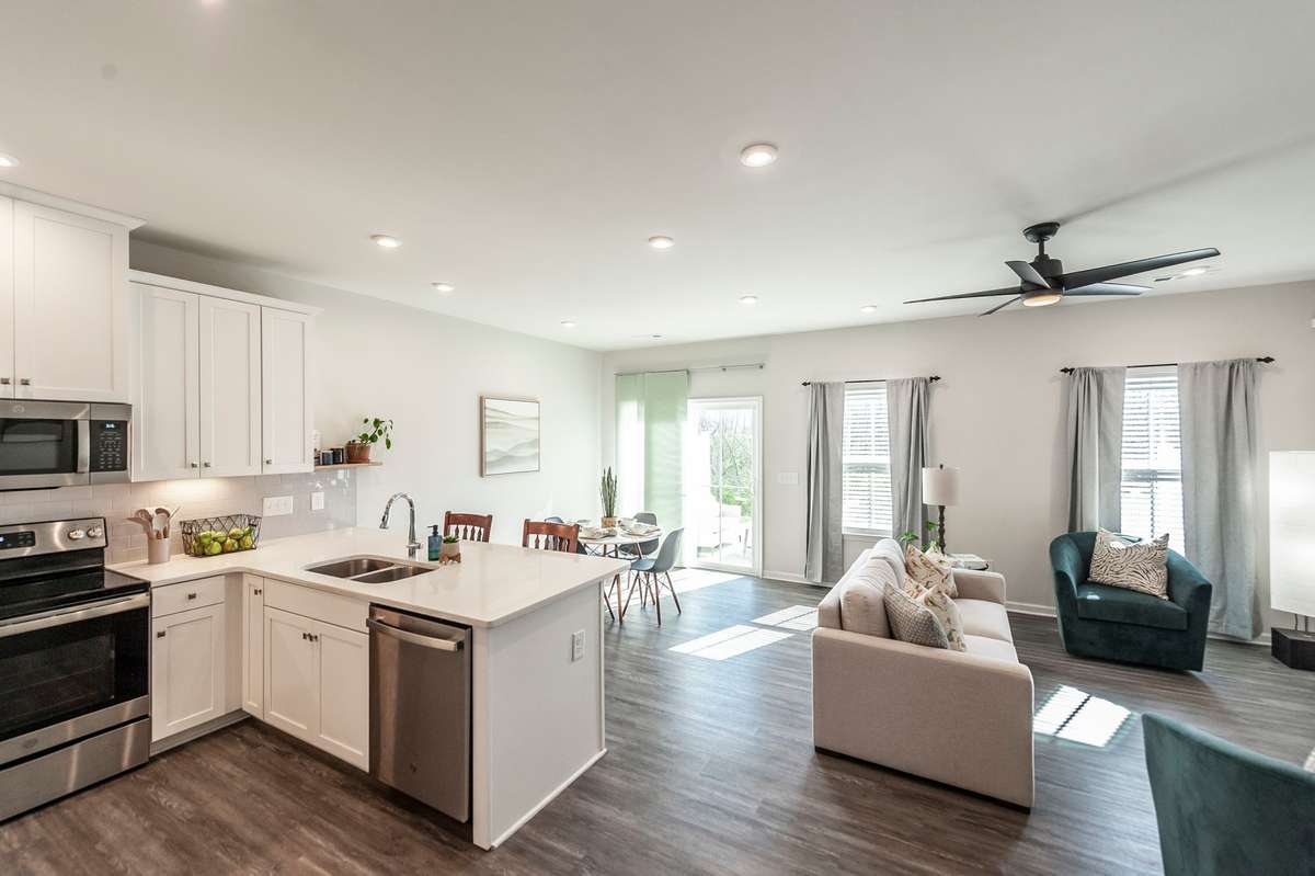 Bright and open living space designed for easy everyday living, with a seamless flow between the living room and kitchen.