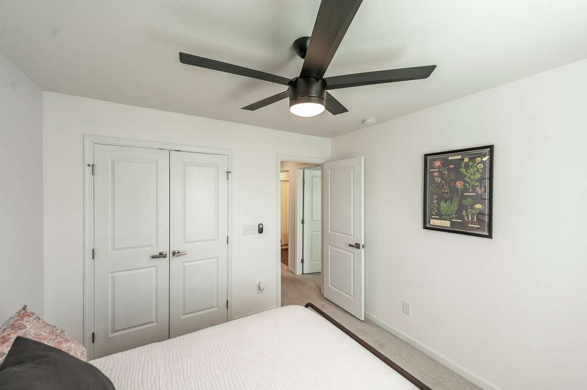 Located conveniently near the guest bathroom, providing easy access and privacy for occupants.