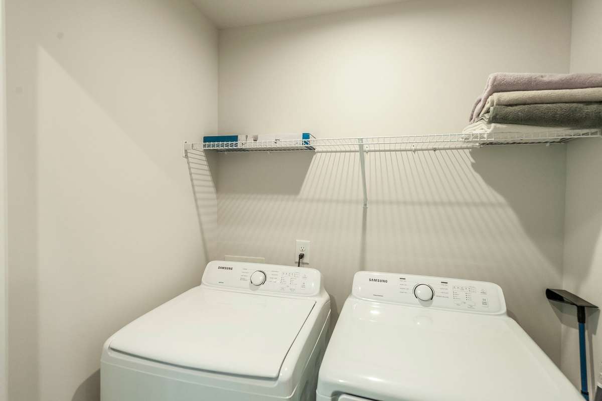 Convenient laundry room comes complete with washer and dryer, a valuable perk not included in new construction.