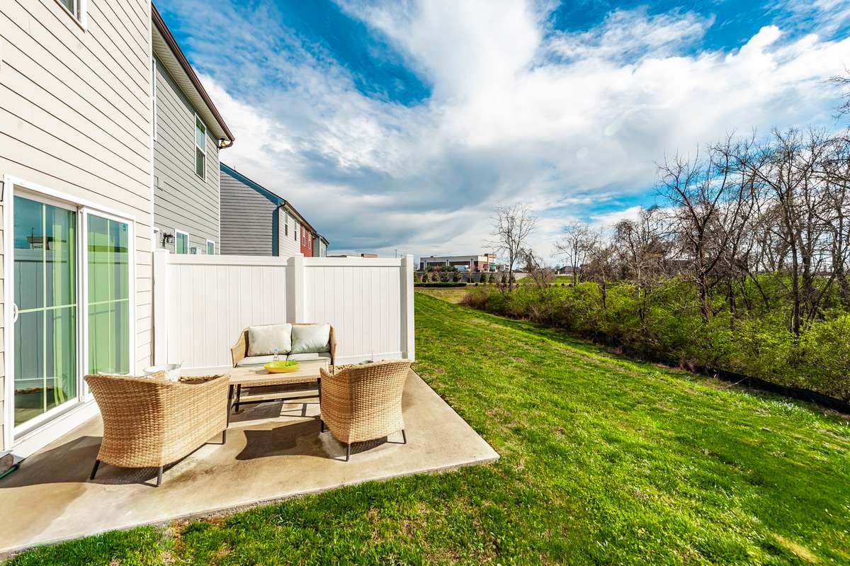 The back patio offers a perfect space for relaxing or entertaining while enjoying the privacy of a premium lot.