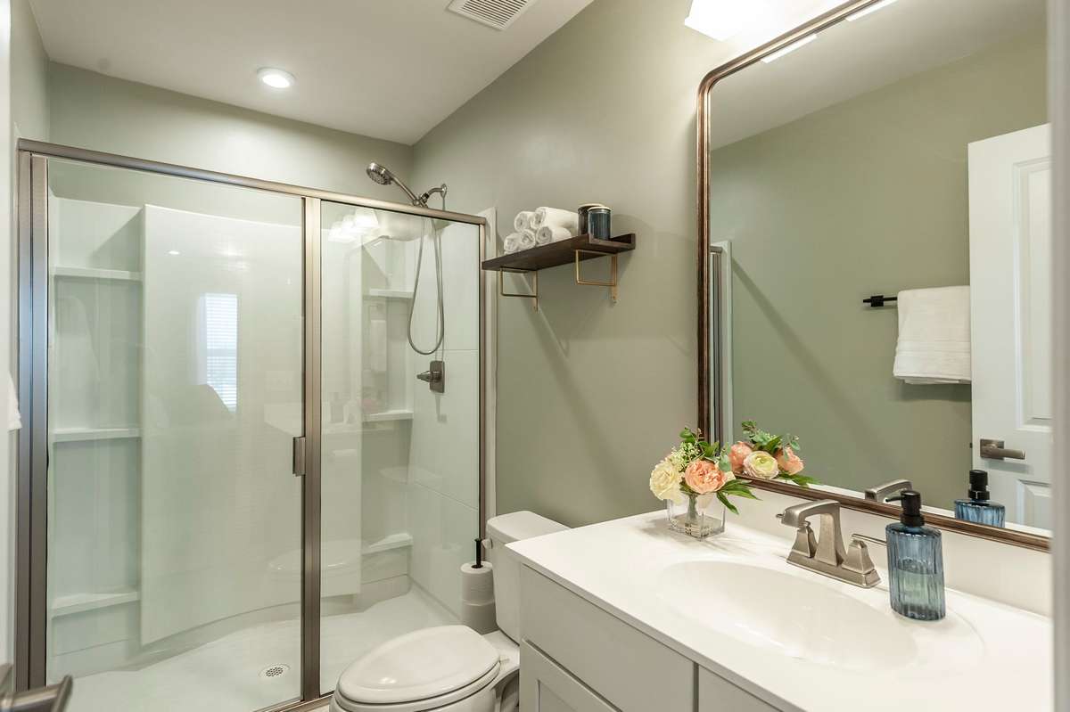 Spacious primary bath featuring a large, glass-enclosed shower that creates a sleek and modern look.