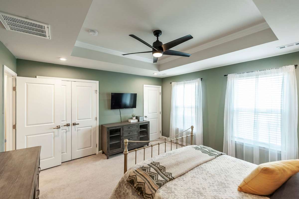 Large windows fill the space with natural light, enhancing the airy and welcoming atmosphere.