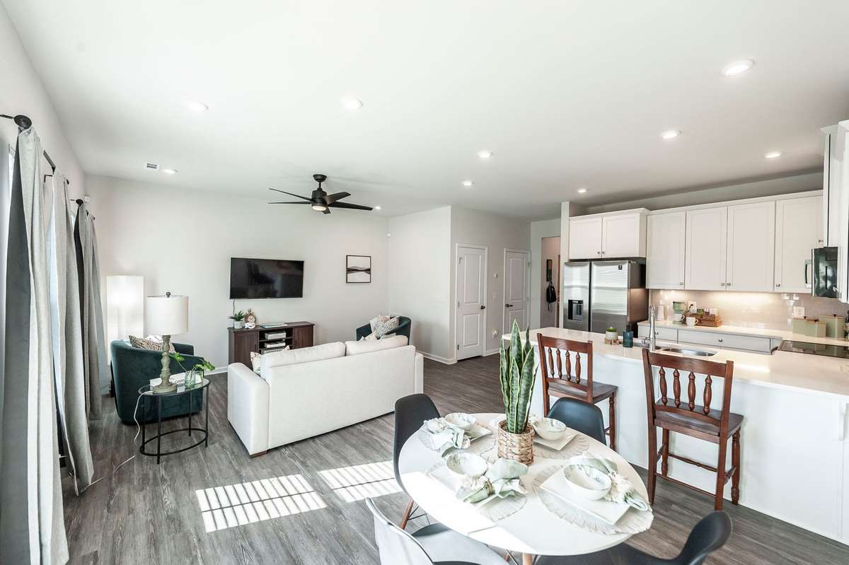 Bright and inviting dining space with natural light pouring in from the patio doors, creating a cheerful spot for everyday meals.