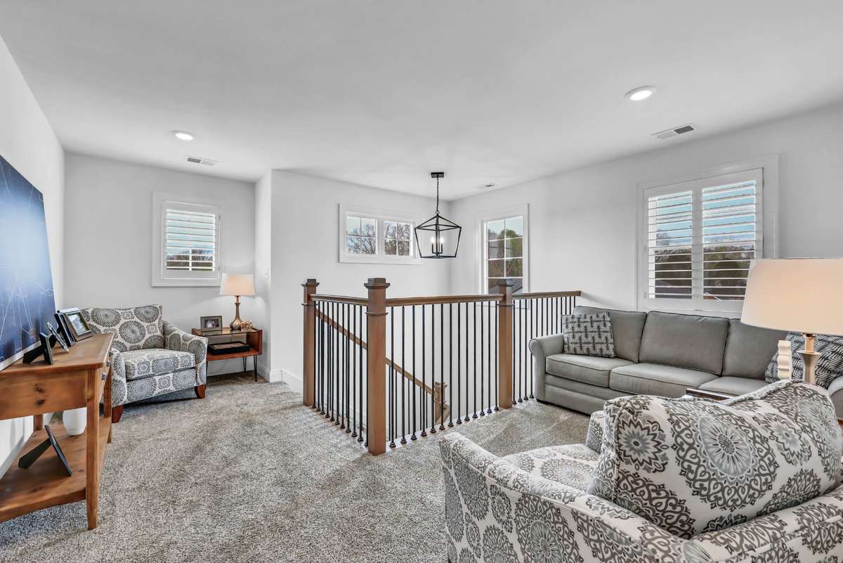 Large windows with plantation shutters bring in natural light, enhancing the warm and comfortable atmosphere. Whether used as a second living area, media room, or home office, this space easily adapts to fit your lifestyle.