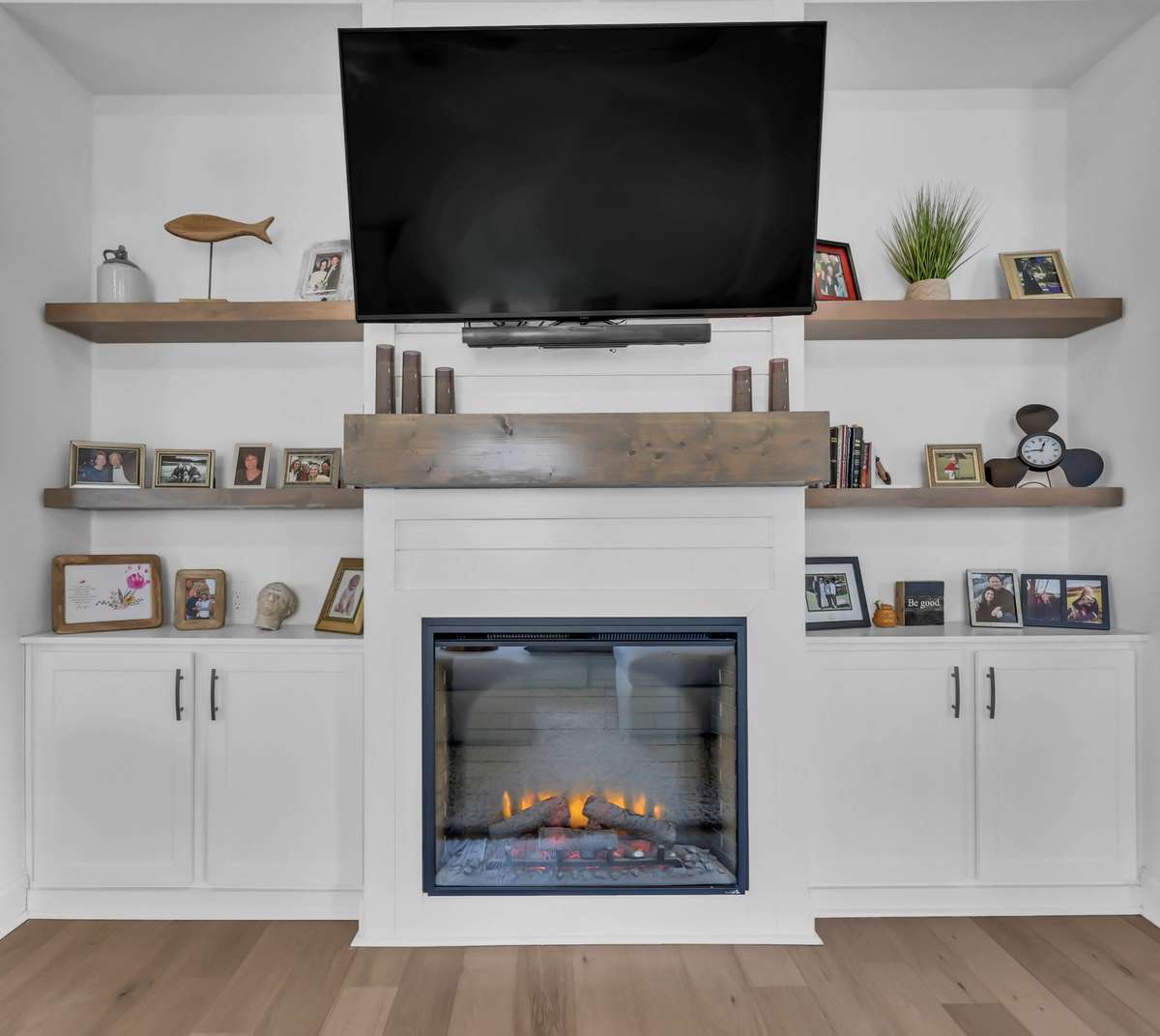 Note the attention to detail with the floating shelves and storage space surrounding the electric fireplace!