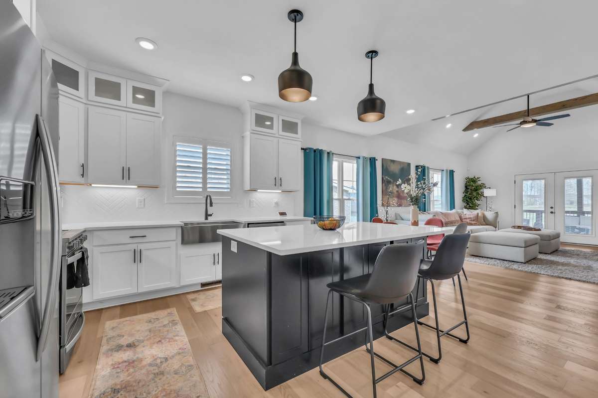 This stunning open-concept living space is designed for both comfort and style, seamlessly connecting the kitchen, dining, and living areas.