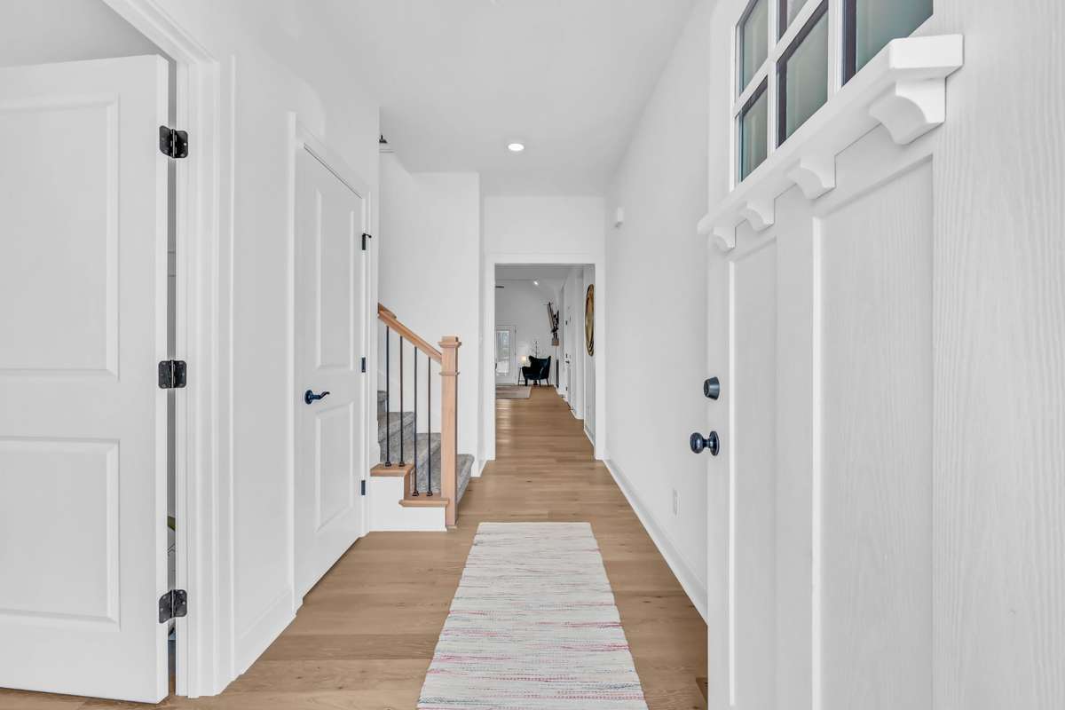 Step inside and feel instantly at home in this bright, beautifully designed Craftsman-style entry. The welcoming foyer features warm wood flooring, crisp white walls, and an abundance of natural light that creates a clean, airy feel!