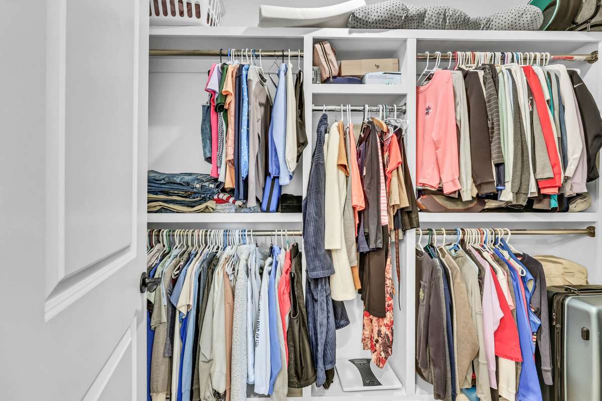 This well-designed walk-in closet offers excellent organization and functionality to keep everything neatly in place. Featuring built-in shelving and multiple hanging areas, there’s plenty of room for clothing, accessories, and storage.
