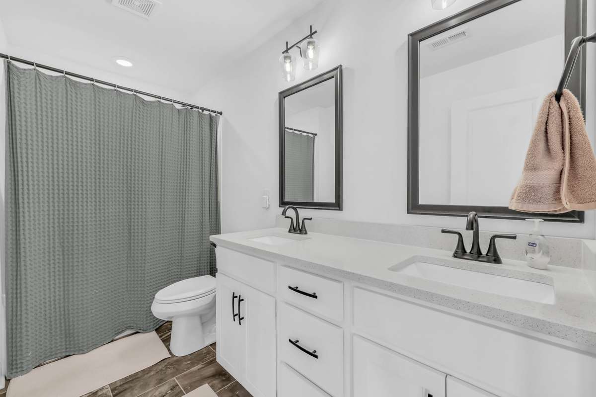 The guest bathroom upstairs has double sinks and a tub/shower combo with tile flooring!