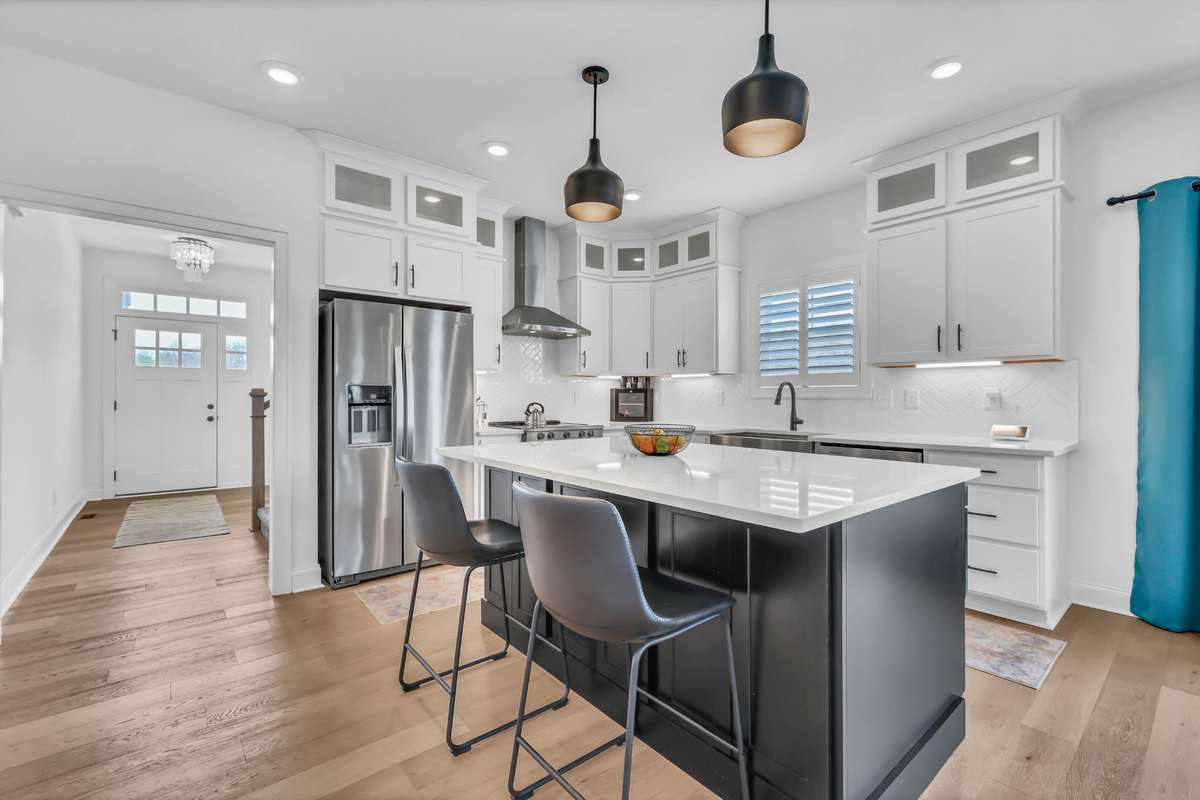 Open to the entry and main living areas, but it also is hidden from the front door. This kitchen offers a seamless flow and welcoming feel—ideal for everyday living and hosting alike.  There is also a window over the sink and glass cabinets above!