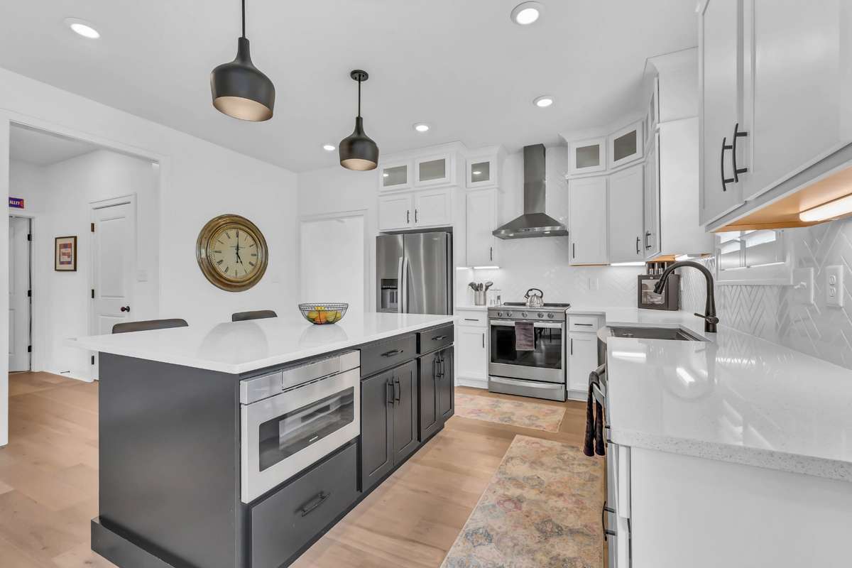 Check it out!  Well appointed location, sleek quartz, microwave in the island, and all the lighting you would need to entertain!