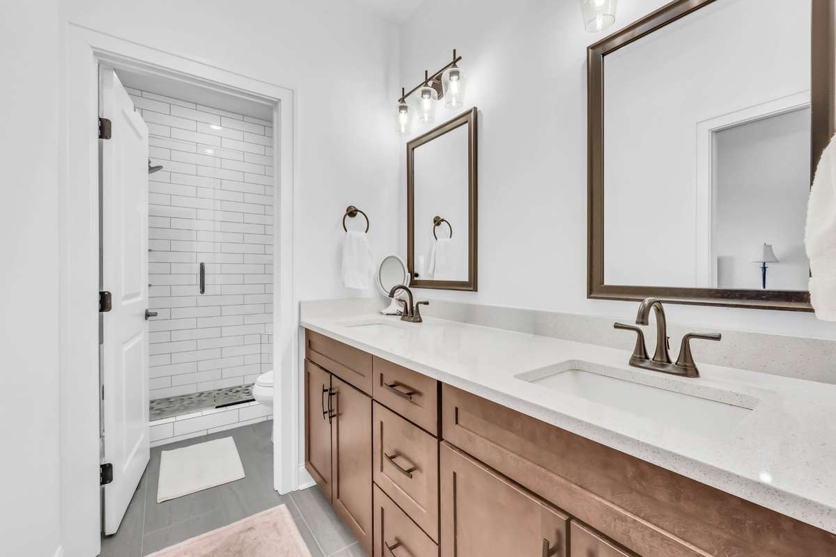 This is the primary bath with lots of storage space and neutral tones, and check out the dreamy shower!