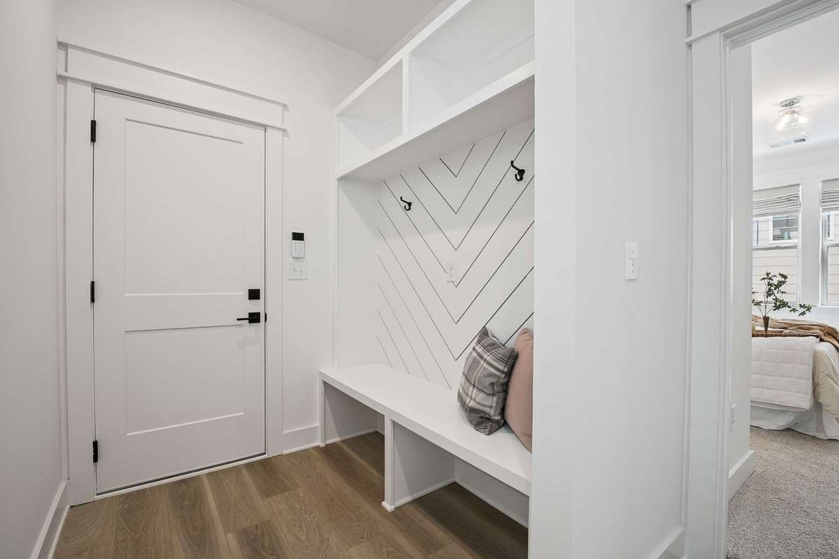 Custom coat rack in mudroom entry off the 2-car garage