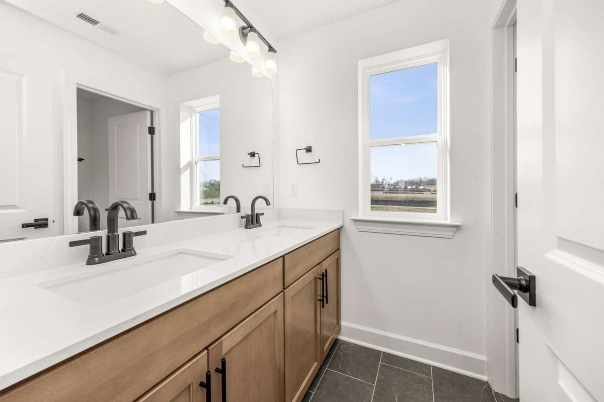 Spacious bathroom with double bowl vanity.