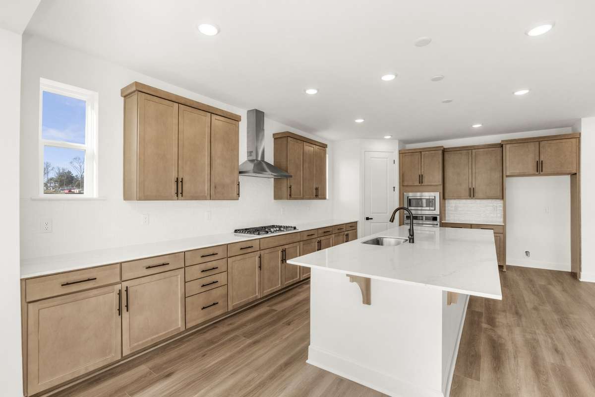 Plenty of cabinetry and oversized kitchen island with quartz countertops