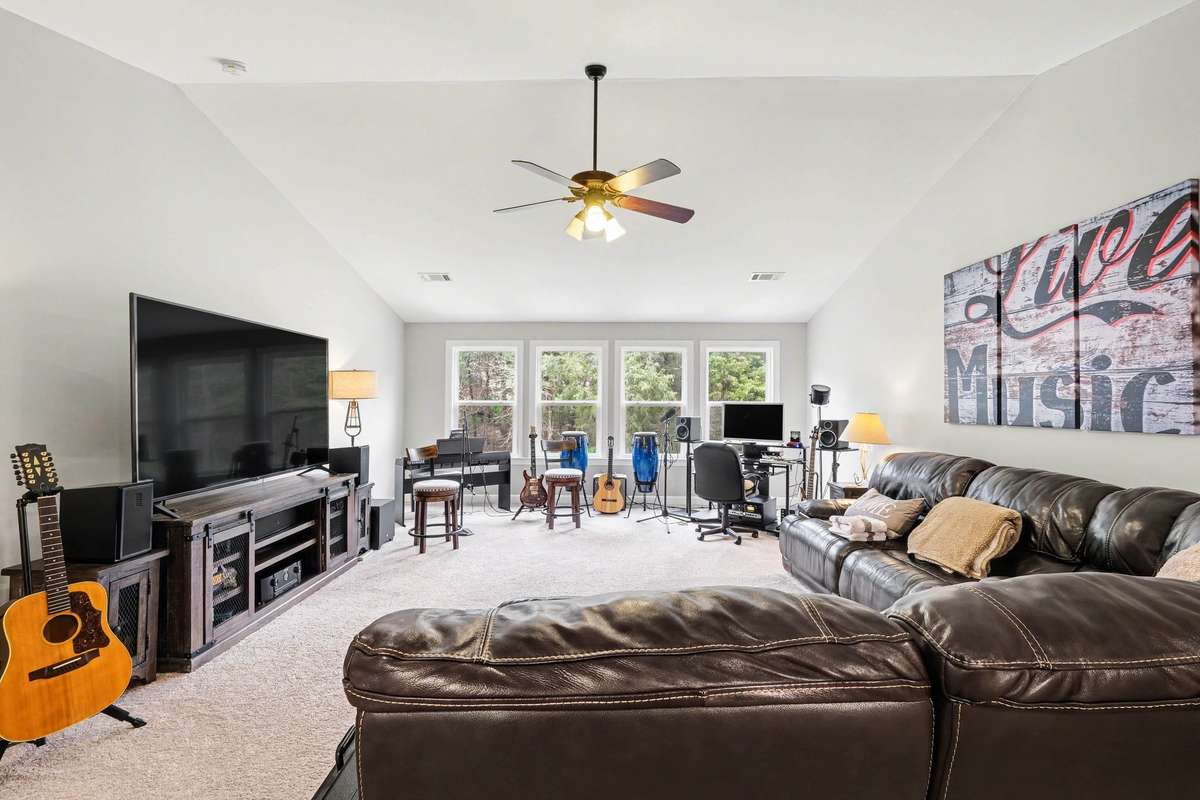 A true entertainer’s dream, this expansive upstairs bonus room offers incredible flexibility with space for a full media setup, music studio, or game area.