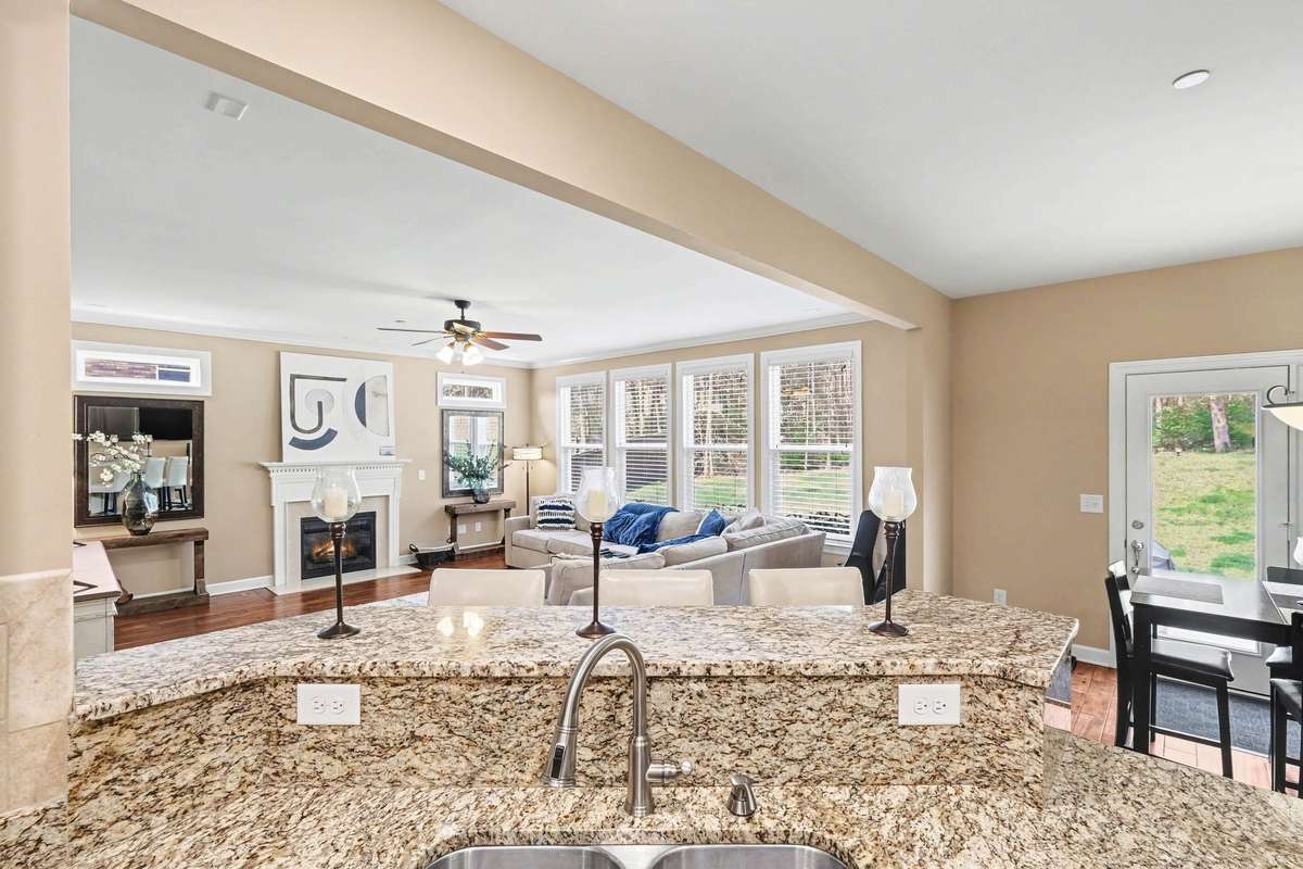 Enjoy seamless open-concept living with this stunning granite island overlooking the spacious family room. Perfect for entertaining or everyday living, this layout features abundant natural light, a cozy fireplace & easy flow to the breakfast area.