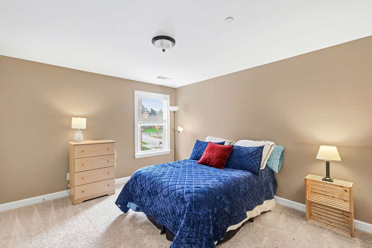 Comfortable upstairs bedroom 4 featuring plush carpeting, neutral tones, and natural light. A well-proportioned space ideal for family, guests, or a home office, offering both comfort and versatility.