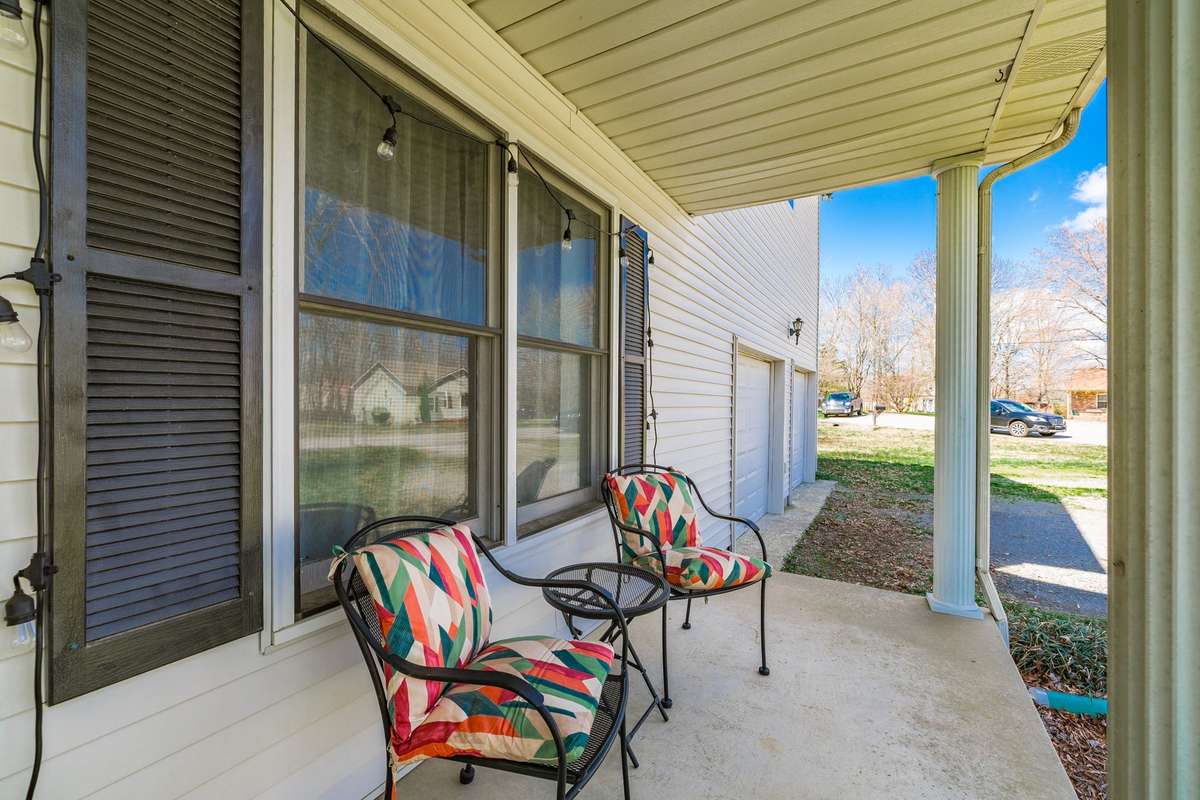 Charming covered front patio- perfect for watching the kids play in the HUGE front yard!