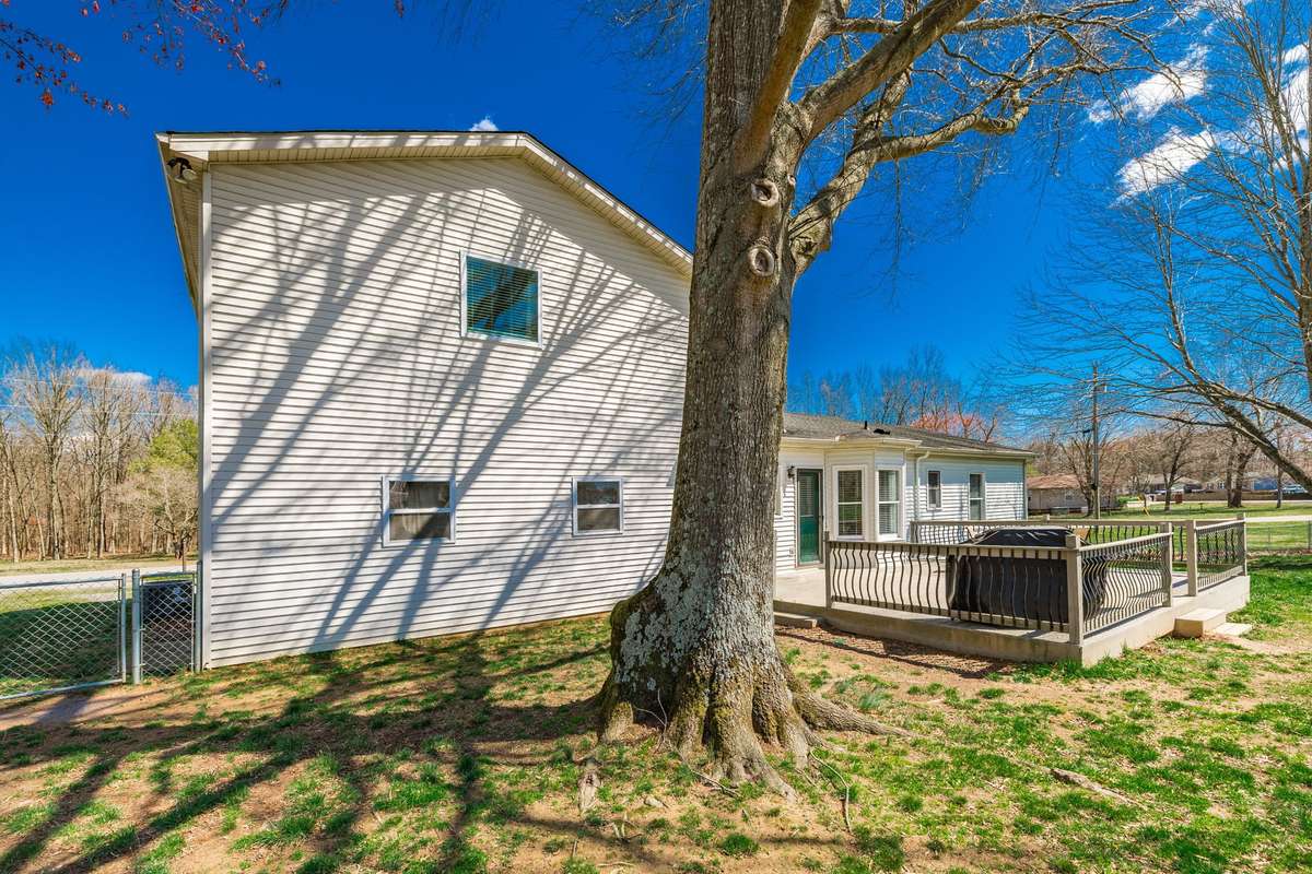 Fenced back yard with huge deck