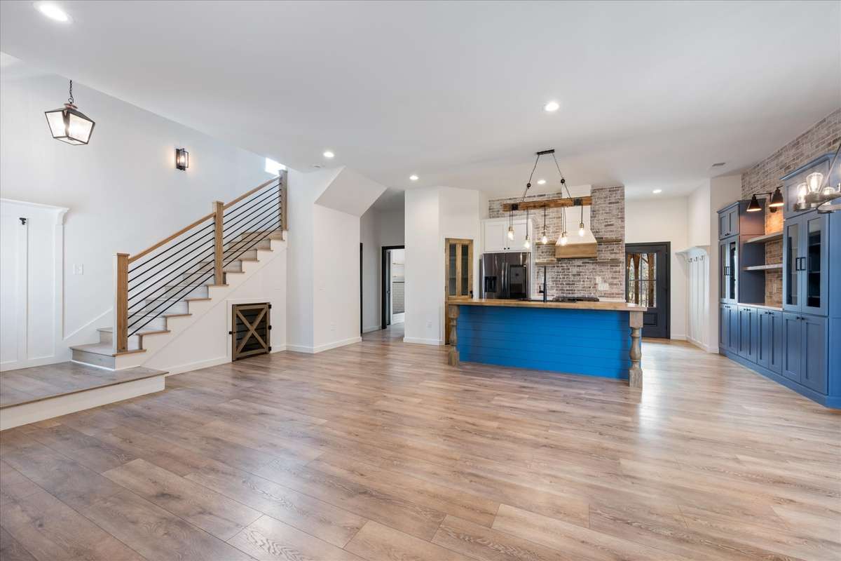 Mid-point living room view to back door and stairs