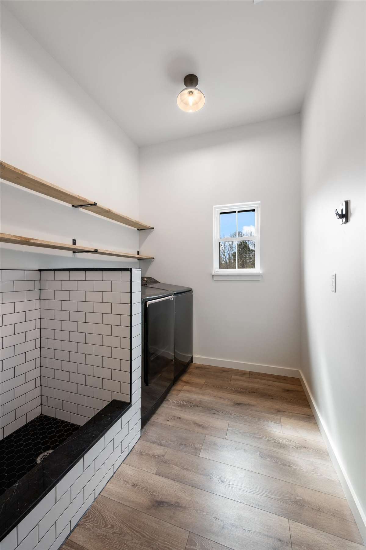 Laundry room and built in dog wash (or could just be used for rinsing yard tools etc as a "mud room."