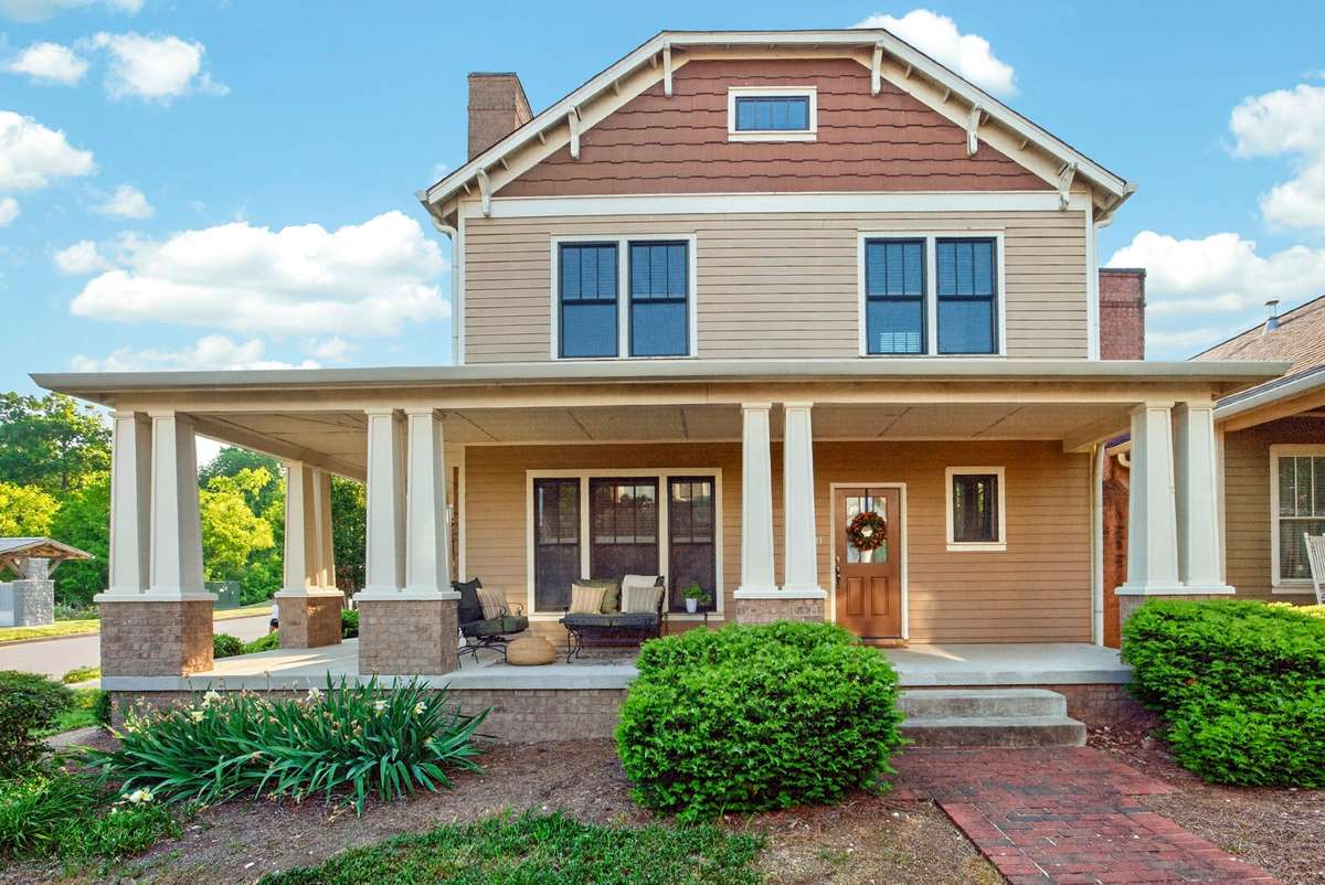 Exterior of the home on a corner lot with a wrap around porch.