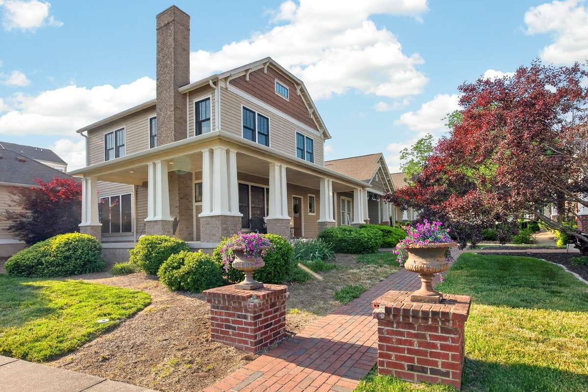 Exterior of the home on a corner lot with a wrap around porch.