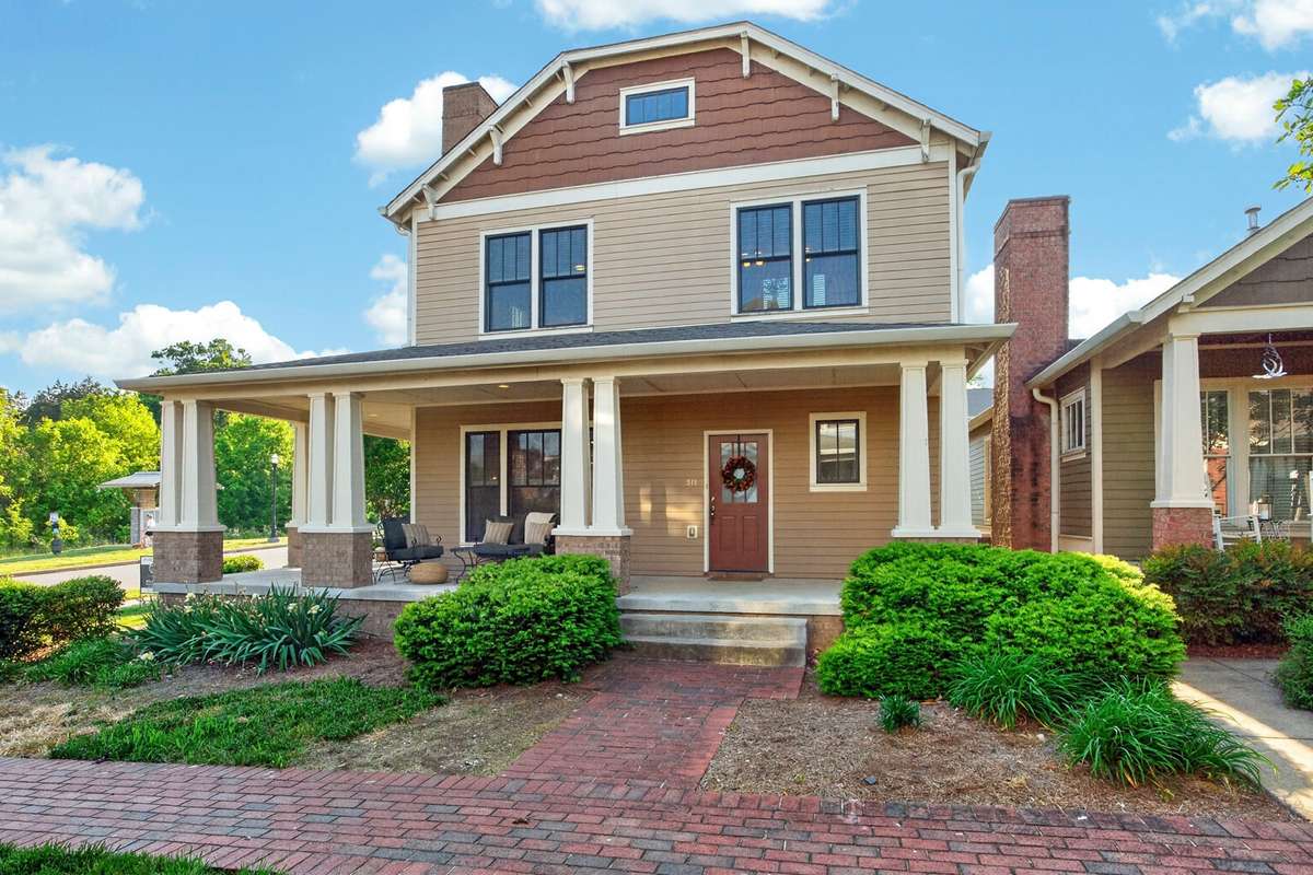 Exterior of the home on a corner lot with a wrap around porch