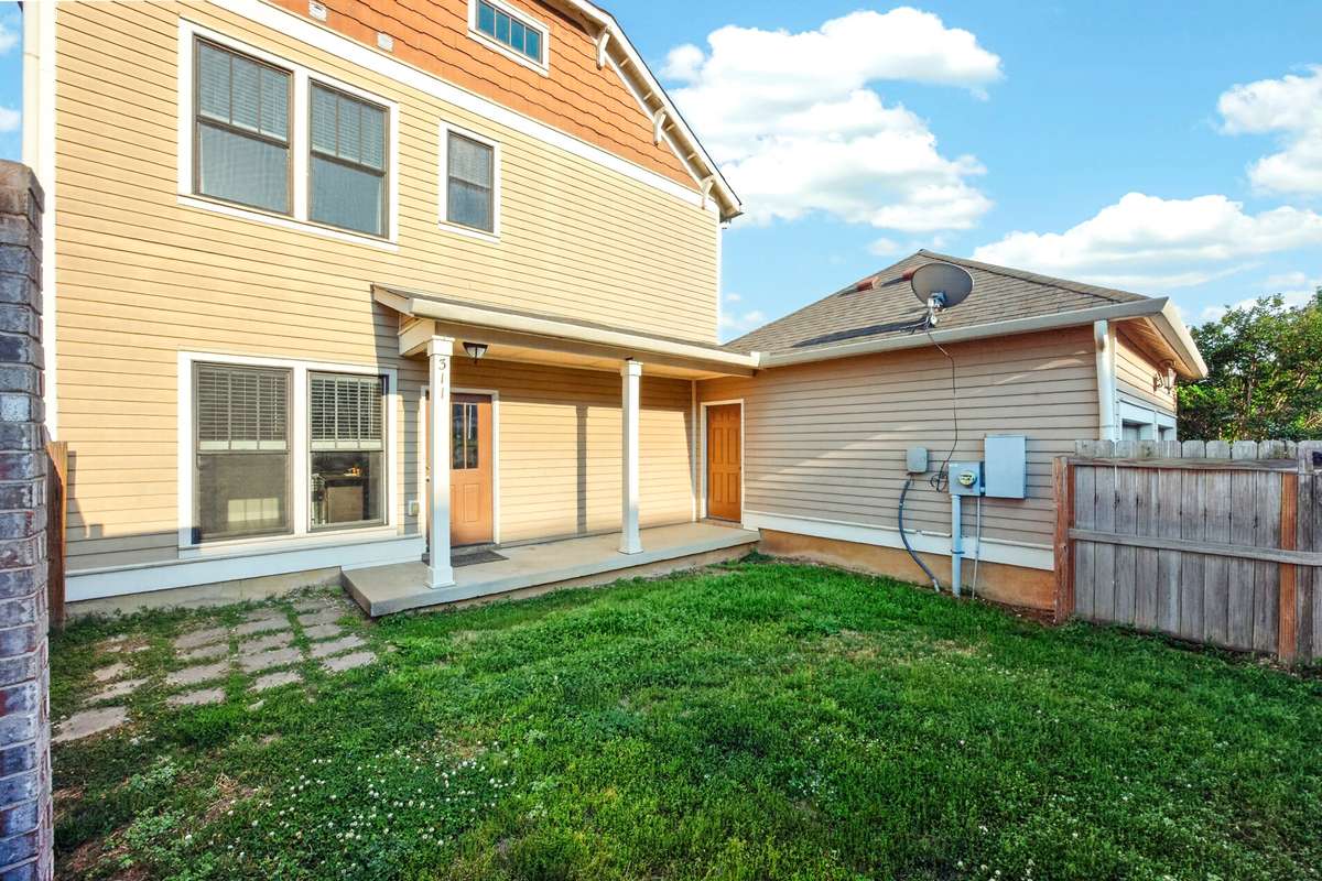 Fenced in backyard and breezeway to attached rear two car garage.