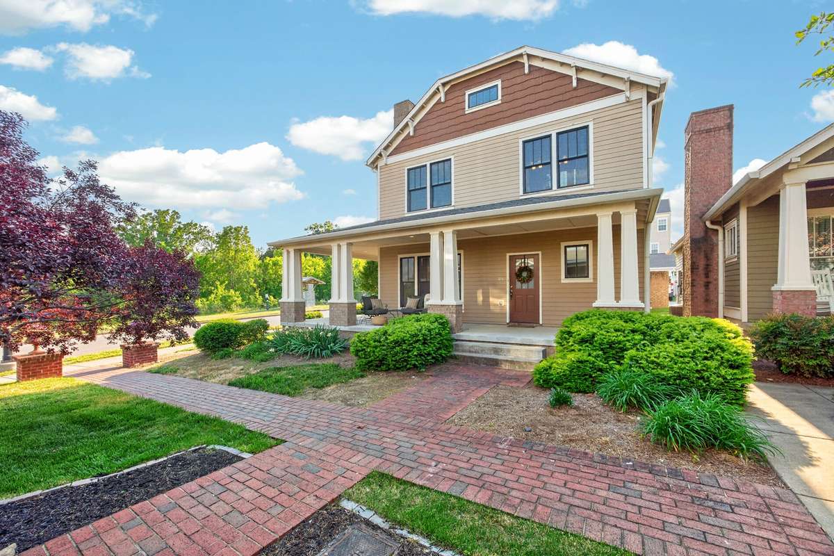 Exterior of the home on a corner lot with a wrap around porch.