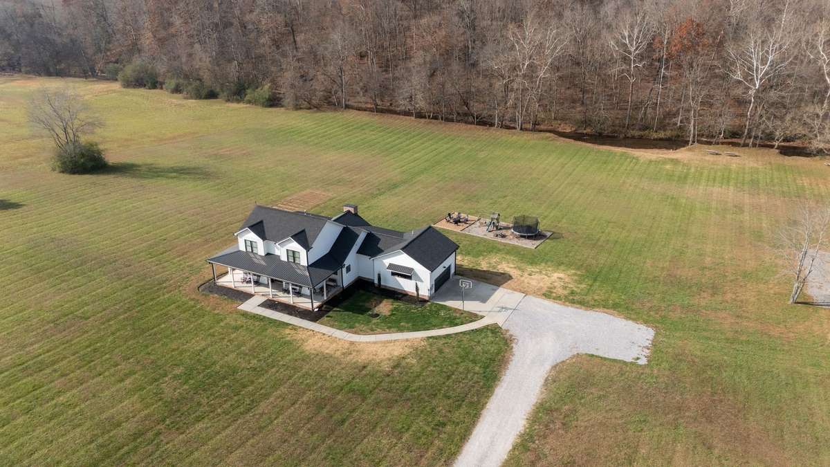 STATEMENT MAKING Home w/ FULL FLOWING CREEK/Year Round!
5.62 ACRES+/-
